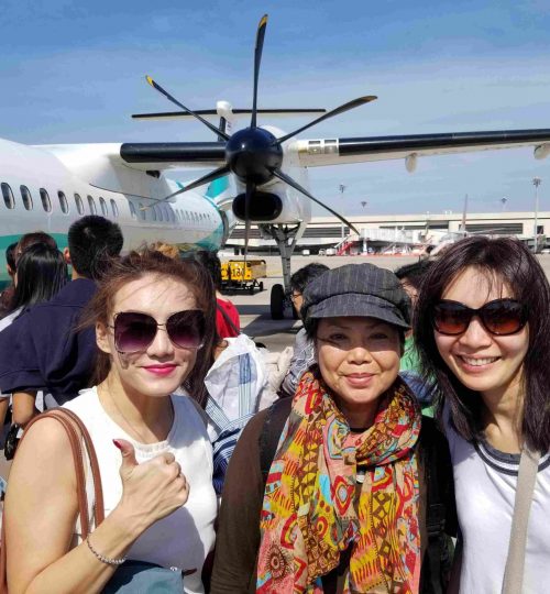 Group of volunteers in front of an airplane